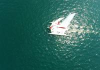 vertical down aerial photo of sailing yacht trimaran nadir